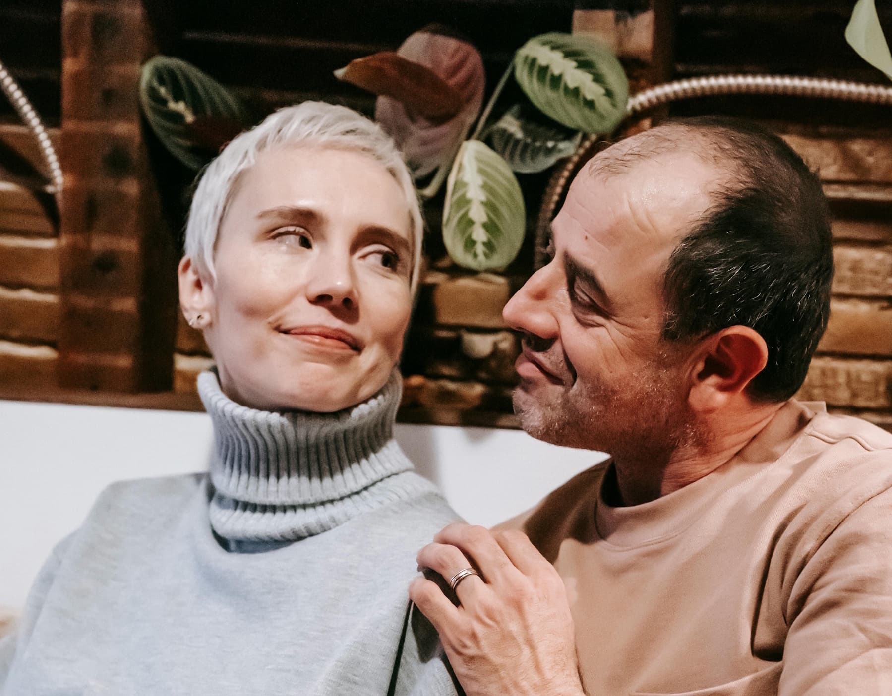 Person writing a letter at a table in natural light